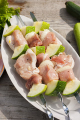 raw kebab on skeawers with vegetables. Picnic