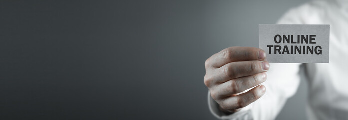 Man showing Online Training text on business card.