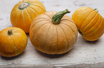 Yellow festive pumpkins on an old surface. October, Halloween. Copy space.