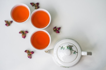 Obraz na płótnie Canvas Rose tea on a white background,top view