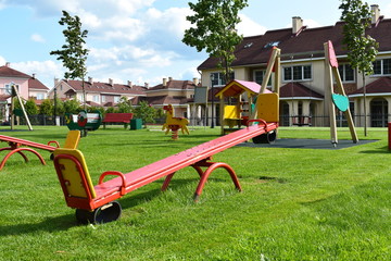 Obraz na płótnie Canvas Wooden swing on children playground. New playground in cottage settlement.