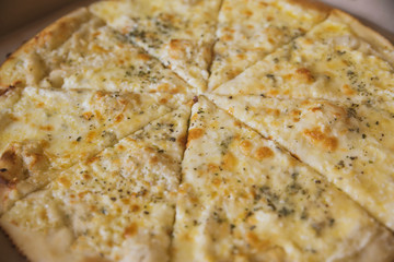 juicy pepperoni pizza and 4 cheeses in a package and on the table