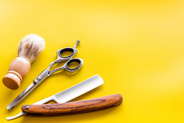 Men's shaving and hairdressing background on yellow top view copy space