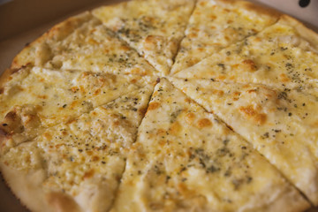 juicy pepperoni pizza and 4 cheeses in a package and on the table