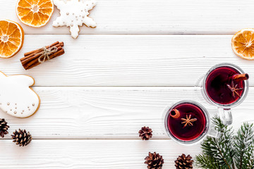 Mulled wine and fir branches frame on white wooden background top view space for text