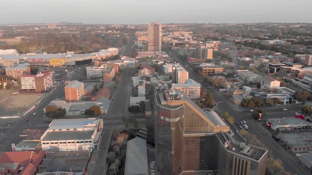 Aerial shot cityscape.Reflective Glass Building in city with palm trees