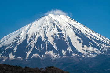 Top Mountain Fuji is covered with snow and blue sky background.