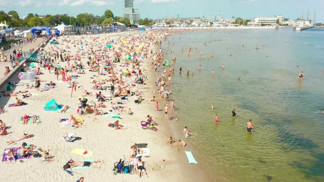 Beach in Gdansk, Poland.  23. August.  2019. Aerial view of the beach with overflows and people swimming in the Baltic Sea. Drone Shot 4K.