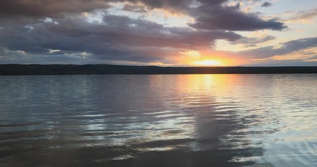 Yellowstone National Park Wyoming sunset forest lake clouds. Beautiful sunset over high Rocky Mountain lake. Pine forest, nature, serenity and peace, landscape environment. Geography, geology.
