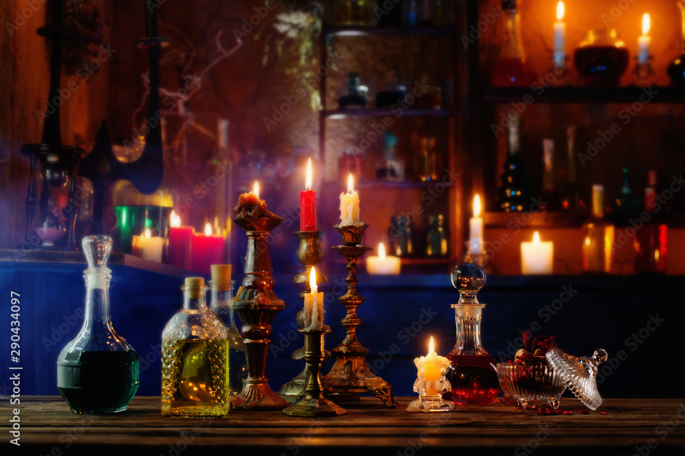 Wall mural magic potions in bottles on wooden background