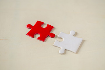 Unfinished red with white jigsaw puzzle pieces