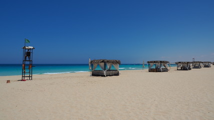 Marsa Matruh, Egypt. Elegant gazebo on the beach. Amazing sea with tropical blue, turquoise and green colors. Relaxing context. Nobody on the beach. Fabulous holidays. Mediterranean Sea. North Africa