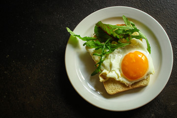 fried eggs with bread or salad leaves - tasty and wholesome food, menu concept. food background. copy space