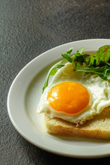 fried eggs with bread or salad leaves - tasty and wholesome food, menu concept. food background. copy space