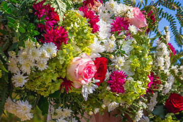 A bouquet of bright flowers, in the center of which is a rose_