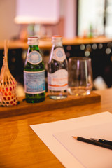 Meeting room empty glass bottles of white wine