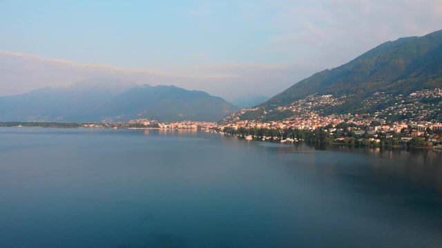 Aerial approach of the lakeside of Locarno with mountains in the background, Switzerland, Lake Maggiore