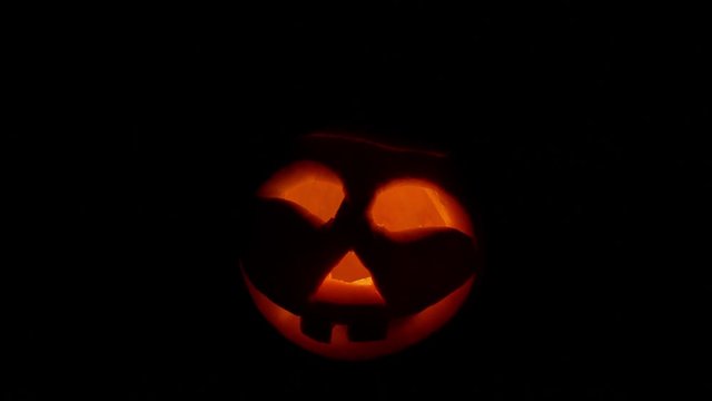 Halloween carved pumpkins burn eyes. Black background.