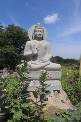 Rock cut Buddha Statue meditating made of stone