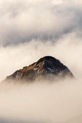 mountain peak looking above clouds