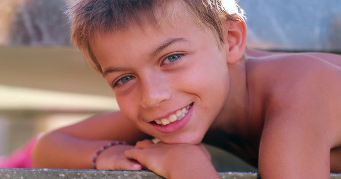Young boy face smiling posing to camera beautiful kid portrait authentic smile