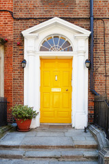 Fototapeta na wymiar A yellow door in Dublin, Ireland.