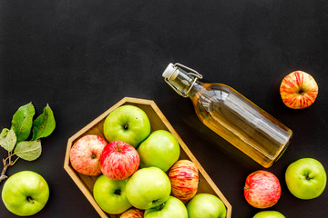 Vinegar made from fresh apple on black background top view space for text