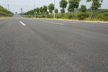 Fototapeta na wymiar Low angle view of a city wide asphalt road