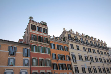 Fototapeta na wymiar Colored facades of houses in a street of Rome