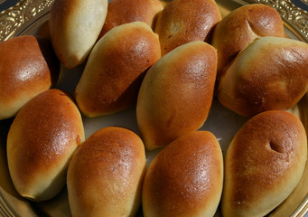 Russian piroshki (patties) with cabbage or potato filling freshly baked and exposed at food market for sale