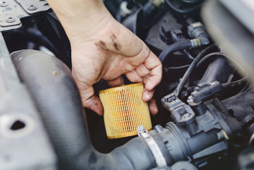 Close up hand of unrecognizable mechanic doing car service and maintenance - Oil and fuel filter changing