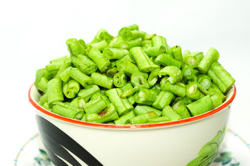  Long beans hatched into plates, placed on a plate on a white background
