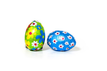 Easter Chocolate Eggs Wrapped with Colored Foil on white Background.