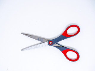 Old gray and red scissors on the White Blackground