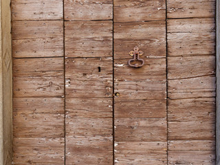 old wooden door on the wall of an italian house