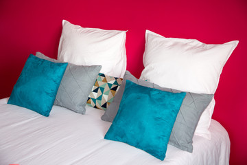 Different pillows on bed in room interior decor