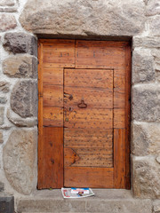 old wooden door on the wall of an italian house
