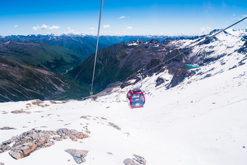 Fototapeta premium cable car on the snow mountains in winter background