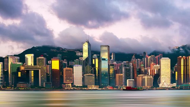 Hong Kong. Skyline of Hong Kong in the morning. Time-lapse of beautiful skyscrapers with colorful sunrise sky from dark to bright. Time-lapse of skyline, apnning video