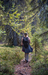 Naklejka na ściany i meble Woman hiking in forest
