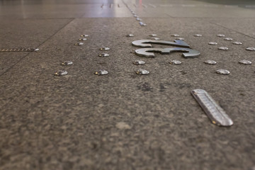 Tactile embossed marks for blind people at the bus station, which indicate the platform number for...