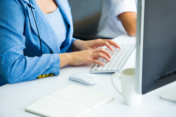 Fototapeta premium Business woman use computer for online shopping and typing on keyboard at Home office with white cup of coffee