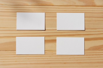 blank white paper on wood background. business card with rustic style.
