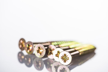 close up view of shiny heads of metal studs isolated on white