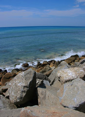 Fototapeta na wymiar Rock on the beach with blue sea and sky