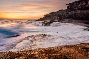 Large waves smash against the rocky roastline of Sydney