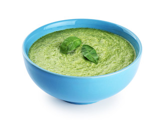 Bowl of green cream soup with pea, broccoli, kale and spinach  isolated on white background.