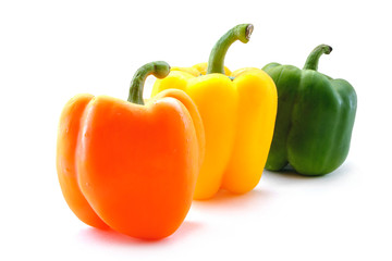 Fresh orange yellow and green bell pepper isolated on white background