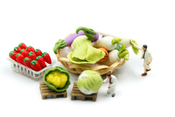 Miniature people : Worker farmer market painting vegetables.