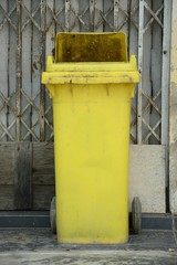 close up old yellow plastic bin